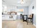 Kitchen with breakfast nook, white cabinets, and tile floor at 3466 Maclaren Dr, Palm Harbor, FL 34684