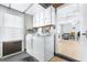 Laundry room with washer, dryer, and cabinets at 3466 Maclaren Dr, Palm Harbor, FL 34684