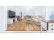 Open living space with hardwood floors and a TV at 3466 Maclaren Dr, Palm Harbor, FL 34684