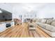 Bright living room with hardwood floors, comfy seating, and a large TV at 3466 Maclaren Dr, Palm Harbor, FL 34684