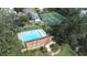 Community pool and tennis courts with surrounding trees at 3466 Maclaren Dr, Palm Harbor, FL 34684