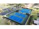 Aerial view of multiple blue tennis courts at 3466 Maclaren Dr, Palm Harbor, FL 34684