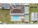Community pool, shuffleboard courts, and parking area, an aerial view at 37340 Neukom Ave, Zephyrhills, FL 33541