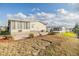 Mobile home with a large backyard, showcasing landscaping and neighboring homes at 37340 Neukom Ave, Zephyrhills, FL 33541
