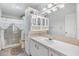 Clean bathroom with a vanity, shower, and a large mirror at 37340 Neukom Ave, Zephyrhills, FL 33541