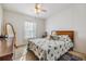 Second bedroom with a wooden bed frame and seashell bedding at 37340 Neukom Ave, Zephyrhills, FL 33541