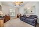 Cozy den with plaid couch and built-in shelving at 37340 Neukom Ave, Zephyrhills, FL 33541