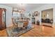 Cozy dining room with wood floor, chandelier, and view into living room at 37340 Neukom Ave, Zephyrhills, FL 33541