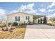 Attractive manufactured home with a covered carport and manicured lawn at 37340 Neukom Ave, Zephyrhills, FL 33541