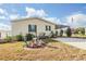 Landscaped yard with decorative garden accents and a home with green shutters at 37340 Neukom Ave, Zephyrhills, FL 33541