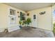 Covered front porch with potted plants and access to home at 37340 Neukom Ave, Zephyrhills, FL 33541