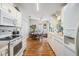 Clean kitchen with white cabinetry, laminate flooring, and ample counter space at 37340 Neukom Ave, Zephyrhills, FL 33541