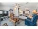 Spacious living room featuring a large TV and comfortable seating at 37340 Neukom Ave, Zephyrhills, FL 33541
