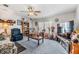 Living room with comfy seating, large TV, and built-in shelving at 37340 Neukom Ave, Zephyrhills, FL 33541