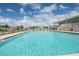 Refreshing community pool with surrounding lounge chairs and landscaping at 37340 Neukom Ave, Zephyrhills, FL 33541