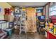Storage or workshop area with various items and shelving at 37340 Neukom Ave, Zephyrhills, FL 33541