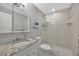 Bathroom featuring vanity with marble countertop and glass shower at 4827 Coquina Key Se Dr # B, St Petersburg, FL 33705