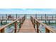 Relaxing dock featuring a comfortable wooden chair, providing stunning views of the tranquil ocean at 4827 Coquina Key Se Dr # B, St Petersburg, FL 33705