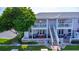 Charming pink two-story home with balconies and outdoor seating, surrounded by lush greenery, a waterfront retreat at 4827 Coquina Key Se Dr # B, St Petersburg, FL 33705