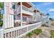 Charming two-story pink home with white balconies and outdoor seating, perfect for enjoying the waterfront view at 4827 Coquina Key Se Dr # B, St Petersburg, FL 33705