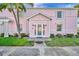 Charming pink condo with well-manicured landscaping and a welcoming covered front entrance at 4827 Coquina Key Se Dr # B, St Petersburg, FL 33705