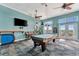 Community game room featuring a pool table, poker table, TV, and comfortable seating for residents to enjoy at 4827 Coquina Key Se Dr # B, St Petersburg, FL 33705