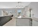 Open-concept kitchen with granite countertop, modern lighting, and a comfortable living area at 4827 Coquina Key Se Dr # B, St Petersburg, FL 33705