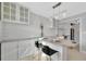 Bright kitchen featuring granite countertops, bar seating, and modern lighting at 4827 Coquina Key Se Dr # B, St Petersburg, FL 33705