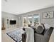 Comfortable living room with modern shelving, television and sliding doors to deck at 4827 Coquina Key Se Dr # B, St Petersburg, FL 33705