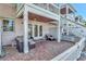 Outdoor patio with brick floor, furniture, ceiling and staircase to second floor at 4827 Coquina Key Se Dr # B, St Petersburg, FL 33705