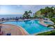 Breathtaking resort-style pool and jacuzzi with ocean views, surrounded by lush landscaping and comfortable lounge areas at 4827 Coquina Key Se Dr # B, St Petersburg, FL 33705