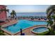 Breathtaking resort-style pool and jacuzzi with ocean views, surrounded by lush landscaping and comfortable lounge areas at 4827 Coquina Key Se Dr # B, St Petersburg, FL 33705