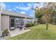 Private backyard patio with seating area and lawn at 9404 Rockbridge Cir # 9404, New Port Richey, FL 34655