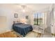 Serene bedroom with a full-size bed and wicker chair at 9404 Rockbridge Cir # 9404, New Port Richey, FL 34655