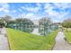 Community tennis court with surrounding fence and landscaping at 9404 Rockbridge Cir # 9404, New Port Richey, FL 34655