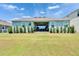 Backyard featuring a well-maintained lawn and covered patio at 1074 Signet Dr, Apollo Beach, FL 33572