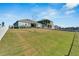 Open backyard with grassy lawn and white fence creating a serene outdoor space at 1074 Signet Dr, Apollo Beach, FL 33572