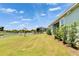 Well-manicured backyard with lush green lawn, waterfront views, and privacy fence at 1074 Signet Dr, Apollo Beach, FL 33572