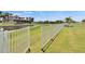 Fenced backyard with waterfront views and lush, green lawn at 1074 Signet Dr, Apollo Beach, FL 33572
