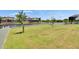 Large backyard offering waterfront views, lush grass, and privacy fence at 1074 Signet Dr, Apollo Beach, FL 33572