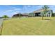 Green backyard with lush lawn and views of neighboring houses at 1074 Signet Dr, Apollo Beach, FL 33572