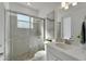 Bathroom with a tile and glass enclosed shower, and quartz countertop at 1074 Signet Dr, Apollo Beach, FL 33572
