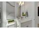 Bathroom featuring a quartz countertop vanity with double lights above the mirror at 1074 Signet Dr, Apollo Beach, FL 33572