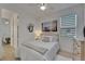 This bedroom features neutral decor, light wood floors, and a ceiling fan at 1074 Signet Dr, Apollo Beach, FL 33572