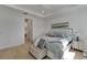 Well lit bedroom with an ensuite features a comfortable bed, side table, and minimalist décor at 1074 Signet Dr, Apollo Beach, FL 33572