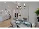Open dining room with chandelier lighting and views into the kitchen and living area at 1074 Signet Dr, Apollo Beach, FL 33572