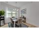 Dining room with natural light from a large window and seating for four at 1074 Signet Dr, Apollo Beach, FL 33572