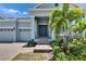 Inviting front entrance with stone steps, tropical plants, and a well-manicured lawn at 1074 Signet Dr, Apollo Beach, FL 33572
