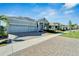 Charming single-story home featuring a three-car garage, stone driveway and well-manicured landscaping at 1074 Signet Dr, Apollo Beach, FL 33572