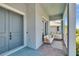 Charming front porch with comfortable seating, offering a welcoming view of the entrance at 1074 Signet Dr, Apollo Beach, FL 33572